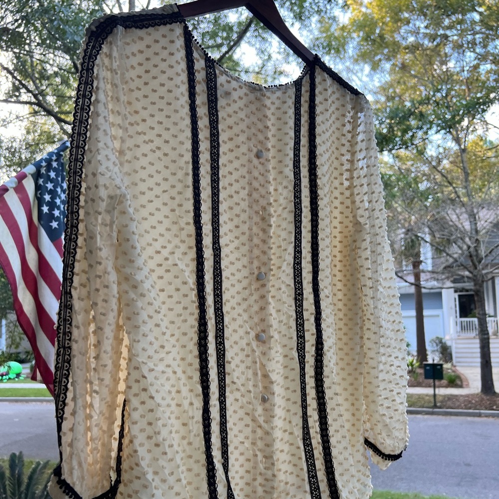 Long sleeve blouse, buttons on the back.